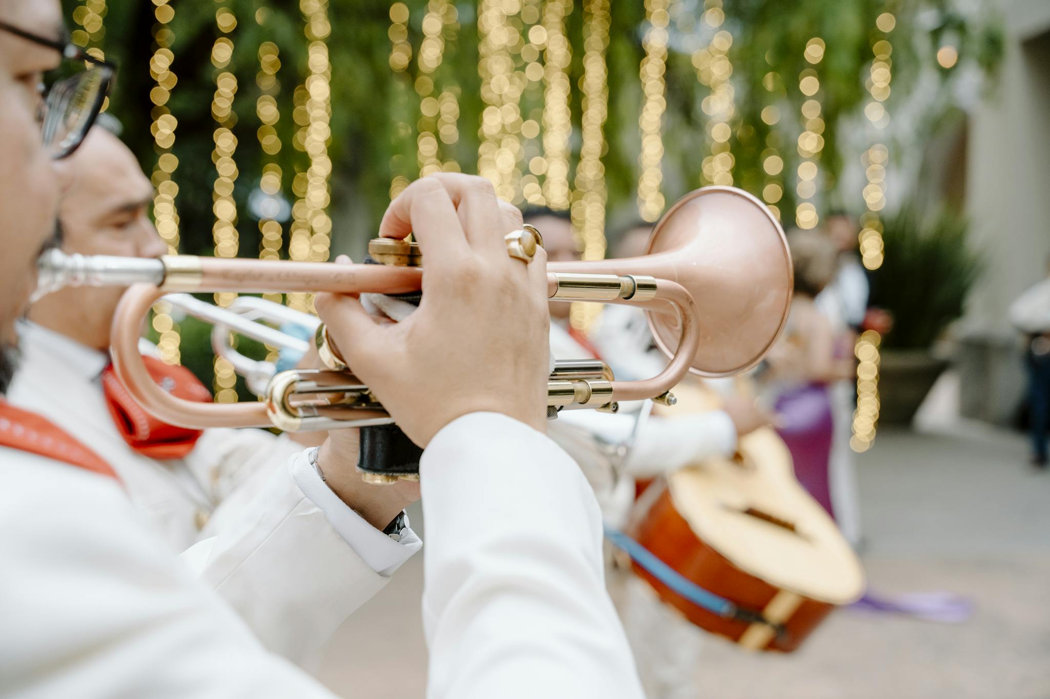 Close-up of an outdoor band playing music at a festive wedding.